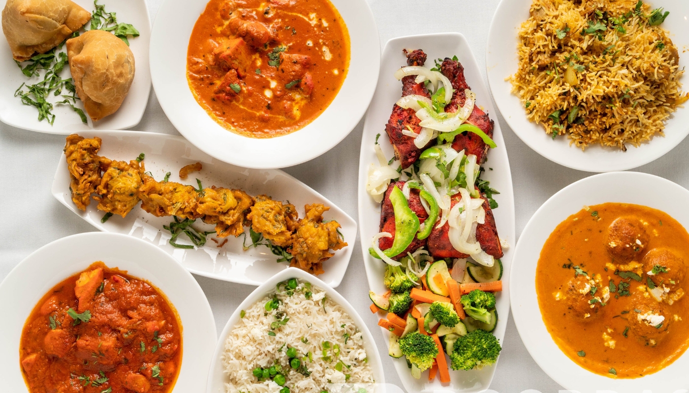 Indian lunch buffet spread with various curries and breads