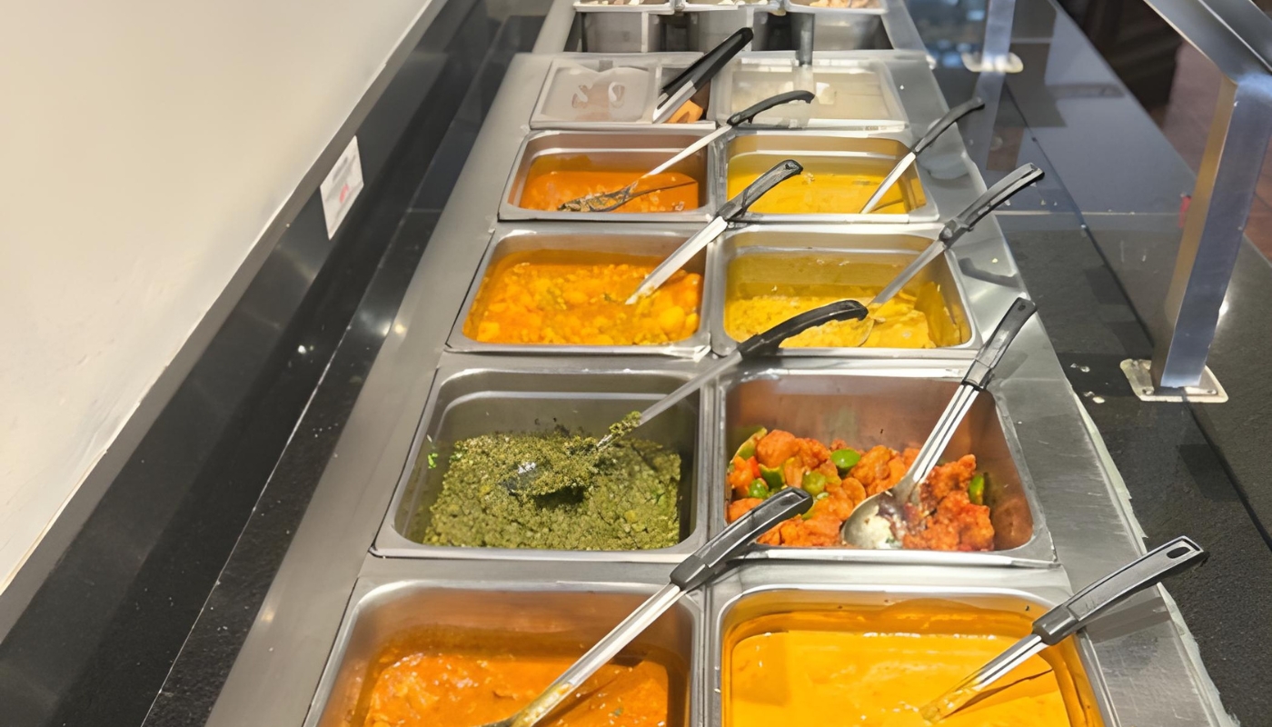 Indian lunch buffet spread with various curries and breads